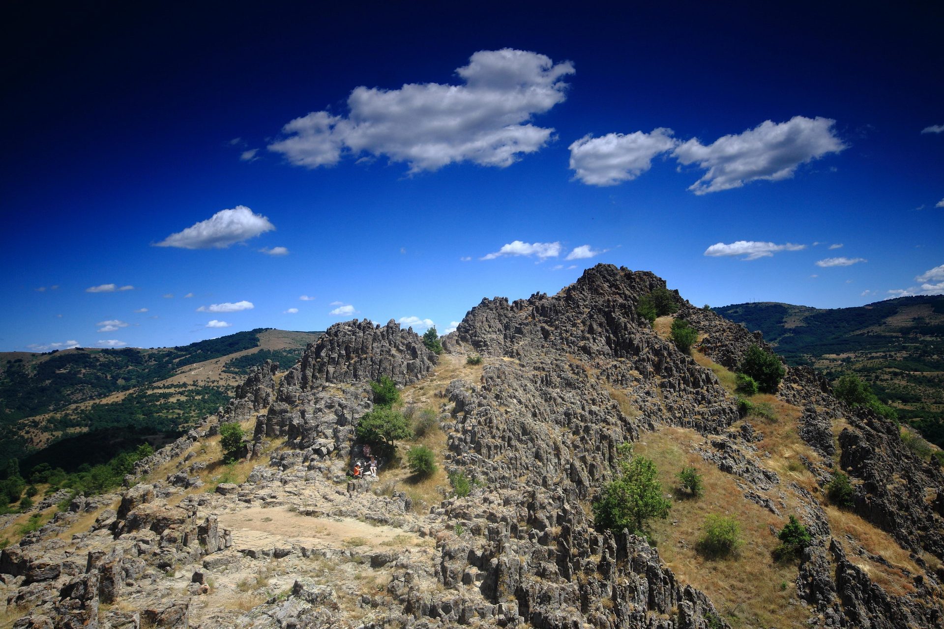 The approach along the ridge at Kokino under a blue summer sky