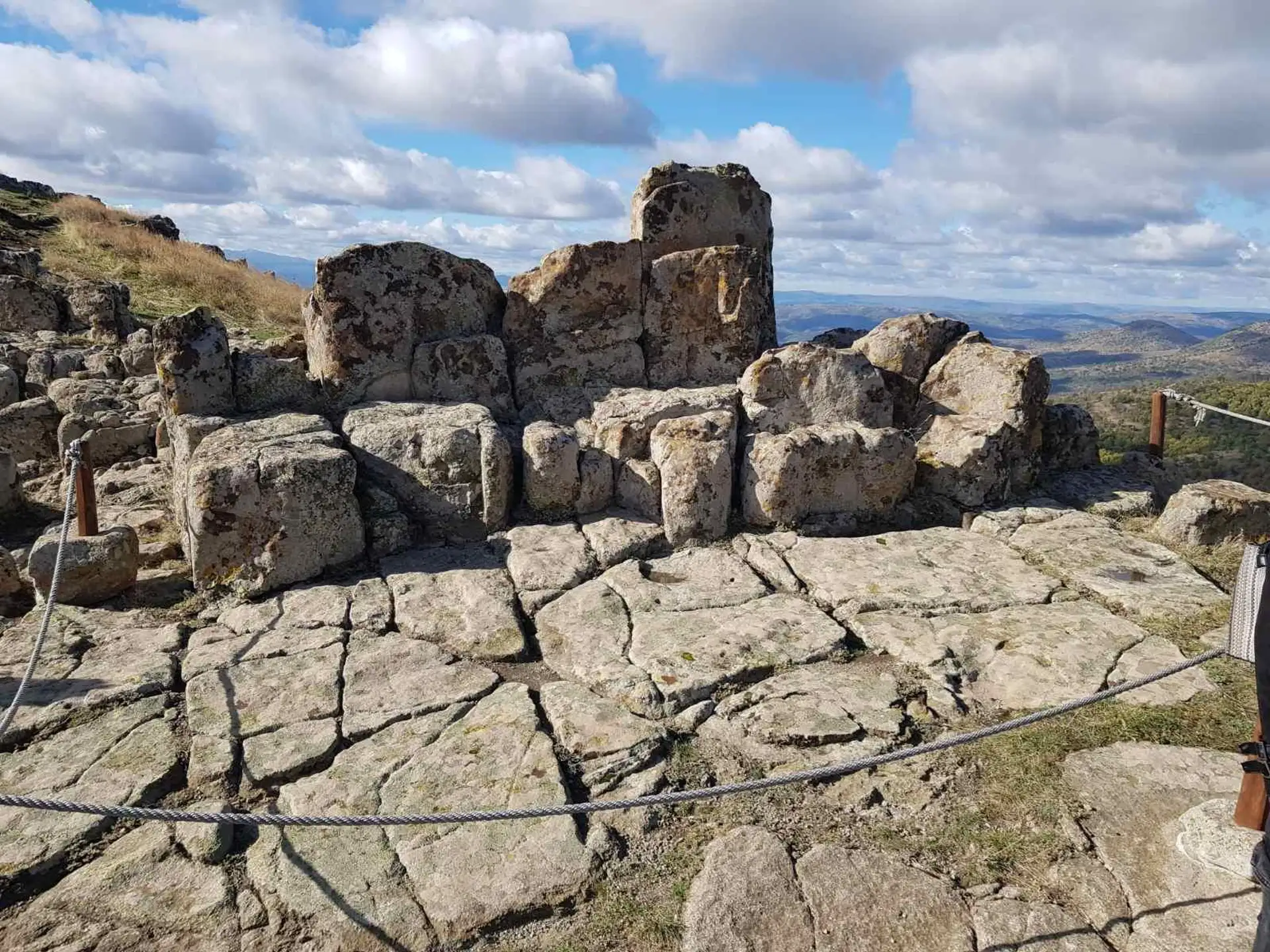 The carved stone thrones on Platform A at Kokino, with the valley beyond